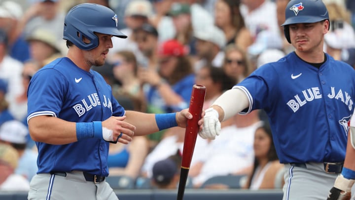 Mar 9, 2025: Toronto Blue Jays third base Addison Barger (47) is congratulated by utfielder Alan Roden (83) after he scored a run during the second inning against the Tampa Bay Rays at Charlotte Sports Park.