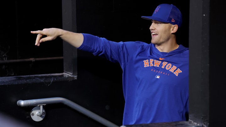 Sep 26, 2023; New York City, New York, USA; New York Mets center fielder Brandon Nimmo (9) watches as members of the grounds crew attempt to dry the field during a delayed start before a game between the Mets and Miami Marlins at Citi Field. Mandatory Credit: Brad Penner-USA TODAY Sports
