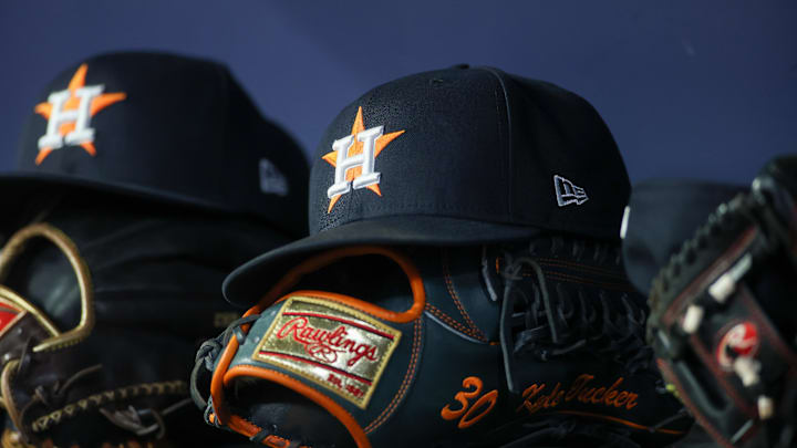 Apr 21, 2023; Atlanta, Georgia, USA; A detailed view of a Houston Astros hat and glove in the dugout against the Atlanta Braves in the fifth inning at Truist Park. 
