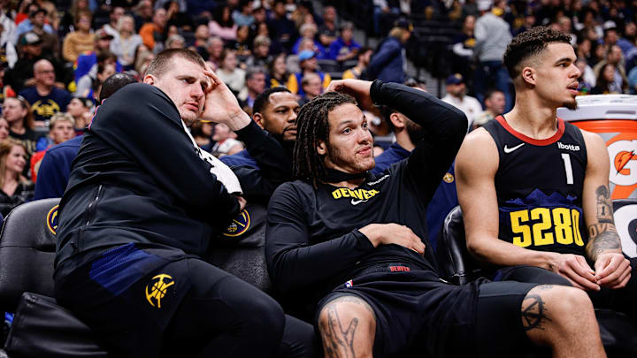 Dec 18, 2023; Denver, Colorado, USA; Denver Nuggets center Nikola Jokic (15) and forward Aaron Gordon (50) and forward Michael Porter Jr. (1) on the bench in the fourth quarter against the Dallas Mavericks at Ball Arena.
