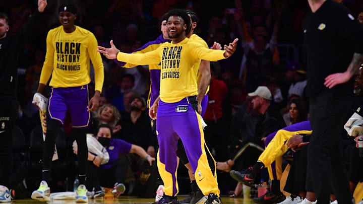 Feb 6, 2025; Los Angeles, California, USA; Los Angeles Lakers guard Bronny James (9) reacts after forward LeBron James (23) scores a three point basket against the Golden State Warriors during the first half at Crypto.com Arena. Mandatory Credit: Gary A. Vasquez-Imagn Images