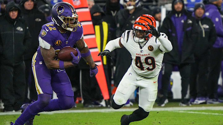 Bengals Barrett Carter (49) rushes Ravens Derrick Henry (22) during their game at M&T Bank Stadium on Thanksgiving Thursday November 27, 2025. The Bengals won the game with a final score of 33-14.
