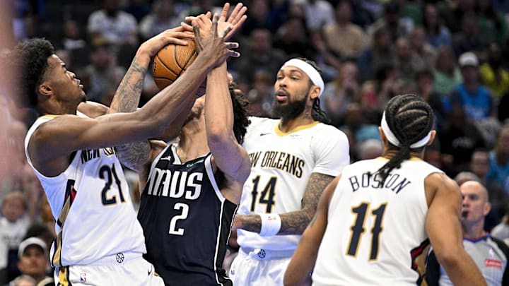 Nov 19, 2024; Dallas, Texas, USA; New Orleans Pelicans center Yves Missi (21) and Dallas Mavericks center Dereck Lively II (2) battle for control of the ball as Pelicans forward Brandon Ingram (14) and Pelicans guard Brandon Boston Jr. (11) look on during the second half at the American Airlines Center. Mandatory Credit: Jerome Miron-Imagn Images