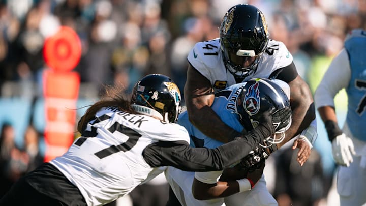 Nov 30, 2025; Nashville, Tennessee, USA;  Jacksonville Jaguars linebacker Dennis Gardeck (47) and defensive end Josh Hines-Allen (41) sack Tennessee Titans quarterback Cameron Ward (1) during the first half at Nissan Stadium. Mandatory Credit: Steve Roberts-Imagn Images