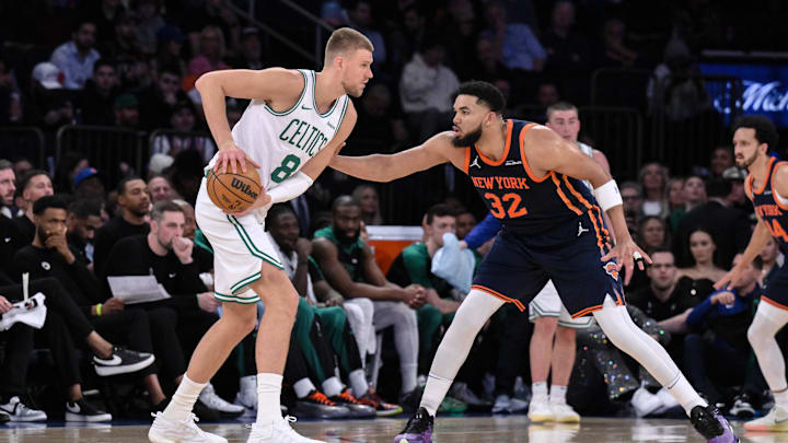 Apr 8, 2025; New York, New York, USA; Boston Celtics center Kristaps Porzingis (8) looks for an opening against New York Knicks center Karl-Anthony Towns (32) during the first half at Madison Square Garden. Mandatory Credit: John Jones-Imagn Images