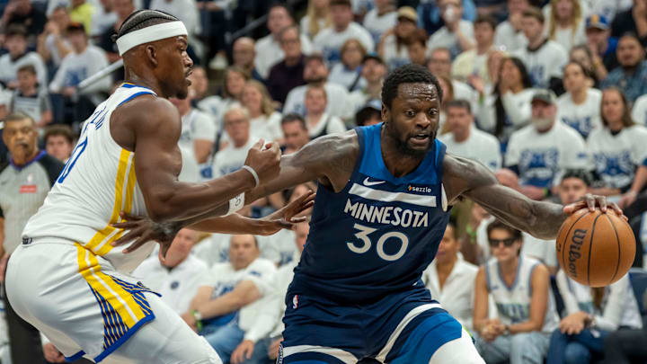 Minnesota Timberwolves forward Julius Randle dribbles the ball past Golden State Warriors forward Jimmy Butler III in the first half during Game 2 of their Western Conference semifinal at Target Center in Minneapolis on May 8, 2025. Minnesota Timberwolves forward Julius Randle dribbles the ball past Golden State Warriors forward Jimmy Butler III in the first half during Game 2 of their Western Conference semifinal at Target Center in Minneapolis on May 8, 2025.