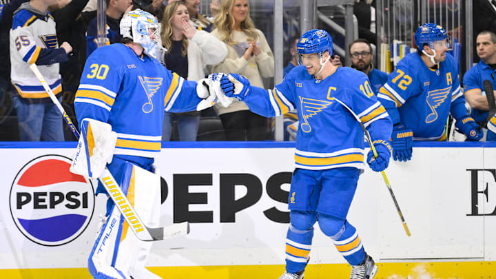 Jan 2, 2026; St. Louis, Missouri, USA; St. Louis Blues center Brayden Schenn (10) is congratulated by goaltender Joel Hofer (30) after scoring the game winning goal against the Vegas Golden Knights during the third period at Enterprise Center. Mandatory Credit: Jeff Curry-Imagn Images