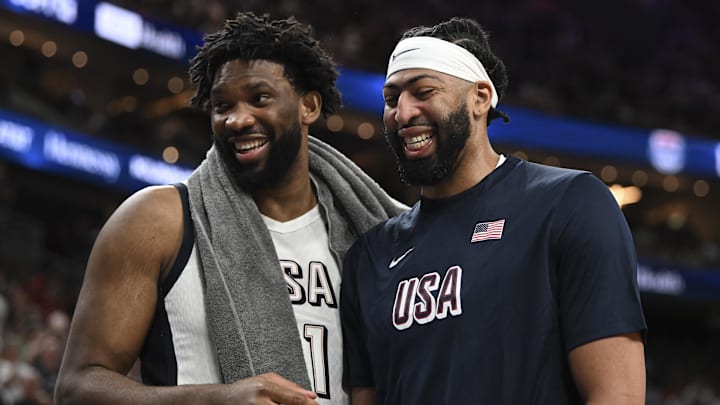 Jul 10, 2024; Las Vegas, Nevada, USA; USA forward Joel Embiid (11) and forward Anthony Davis (14) laugh together on the bench during the fourth quarter against Canada in the USA Basketball Showcase at T-Mobile Arena. Mandatory Credit: Candice Ward-Imagn Images
