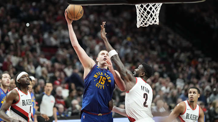  Denver Nuggets center Nikola Jokic (15) shoots the ball against Portland Trail Blazers center Deandre Ayton (2) during the second half at Moda Center. Mandatory Credit: Soobum Im-Imagn Images