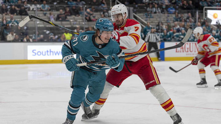 Apr 7, 2025; San Jose, California, USA; Calgary Flames defenseman Kevin Bahl (7) shoves San Jose Sharks center Macklin Celebrini (71) during the second period at SAP Center at San Jose. Mandatory Credit: Stan Szeto-Imagn Images Apr 7, 2025; San Jose, California, USA; Calgary Flames defenseman Kevin Bahl (7) shoves San Jose Sharks center Macklin Celebrini (71) during the second period at SAP Center at San Jose. Mandatory Credit: Stan Szeto-Imagn Images