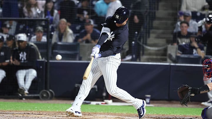 Mar 7, 2025; Tampa, Florida, USA; New York Yankees outfielder Cody Bellinger (35) hits a home run during the first inning against the Toronto Blue Jays at George M. Steinbrenner Field. 