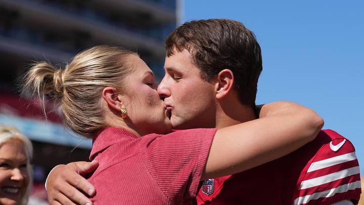 San Francisco 49ers quarterback Brock Purdy (right) kisses his wife Jenna Brandt (left) before the game against the Arizona Cardinals. San Francisco 49ers quarterback Brock Purdy (right) kisses his wife Jenna Brandt (left) before the game against the Arizona Cardinals.