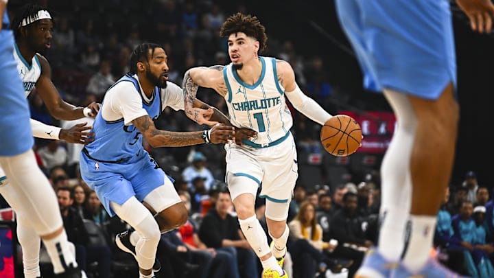 Mar 16, 2025; Inglewood, California, USA; Charlotte Hornets guard LaMelo Ball (1) moves the ball against LA Clippers forward Derrick Jones Jr. (55) during the first half at Intuit Dome. Mandatory Credit: Jonathan Hui-Imagn Images