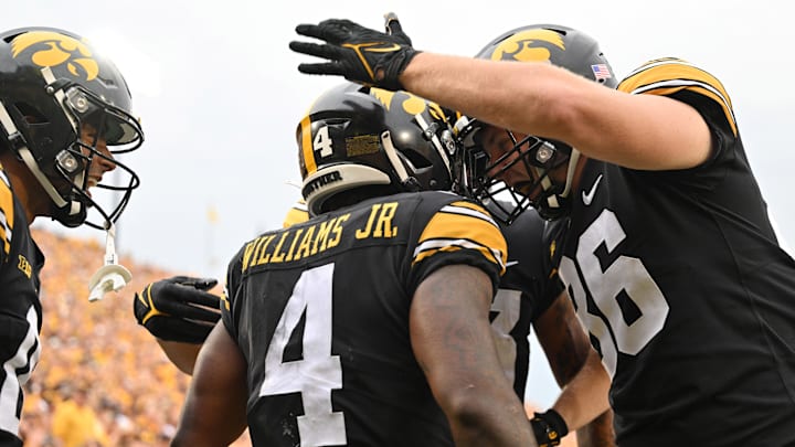 Sep 16, 2023; Iowa City, Iowa, USA; Iowa Hawkeyes tight end Steven Stilianos (86) and wide receiver Diante Vines (0) celebrate with running back Leshon Williams (4) after Williams scored a touchdown during the second quarter against the Western Michigan Broncos at Kinnick Stadium. Mandatory Credit: Jeffrey Becker-USA TODAY Sports
