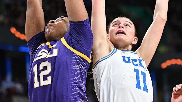 Mar 30, 2025; Spokane, WA, USA; LSU Lady Tigers guard Mikaylah Williams (12) rebounds against UCLA Bruins guard Gabriela Jaquez (11) during the first half of a Elite 8 NCAA Tournament basketball game at Spokane Arena. Mandatory Credit: James Snook-Imagn Images