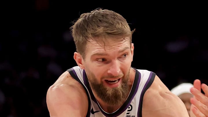 New York Knicks guard Miles McBride grabs a loose ball against Sacramento Kings forward Domantas Sabonis.