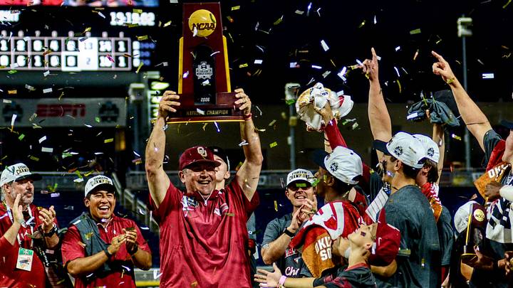 Oklahoma coach Skip Johnson raises the NCAA Championship Trophy after the Sooners won the College World Series. Oklahoma coach Skip Johnson raises the NCAA Championship Trophy after the Sooners won the College World Series.