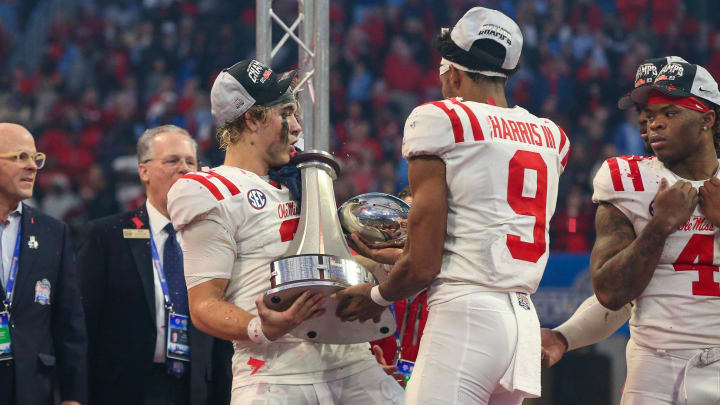 Dec 30, 2023; Atlanta, GA, USA; Mississippi Rebels quarterback Jaxson Dart (2) holds the Peach Bowl trophy as wide receiver Tre Harris (9) catches the top after a victory against the Penn State Nittany Lions at Mercedes-Benz Stadium. Mandatory Credit: Brett Davis-USA TODAY Sports
Dec 30, 2023; Atlanta, GA, USA; Mississippi Rebels quarterback Jaxson Dart (2) holds the Peach Bowl trophy as wide receiver Tre Harris (9) catches the top after a victory against the Penn State Nittany Lions at Mercedes-Benz Stadium. Mandatory Credit: Brett Davis-USA TODAY Sports