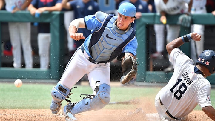 Arizona's Adonys Guzman (18) slides into home plate to score beating the throw to North Carolina catcher Luke Stevenson (44) . The North Carolina Tar Heels and the Arizona Wildcats met in game two of the NCAA Division 1 Super Regionals in Chapel Hill, N.C. on June 7, 2025.