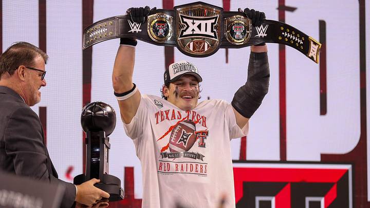 Texas Tech's Ben Roberts lifts the title belt after being named most outstanding player of the Big 12 Conference championship football game, Saturday, Nov. 6, 2025, at AT&T Stadium in Arlington.