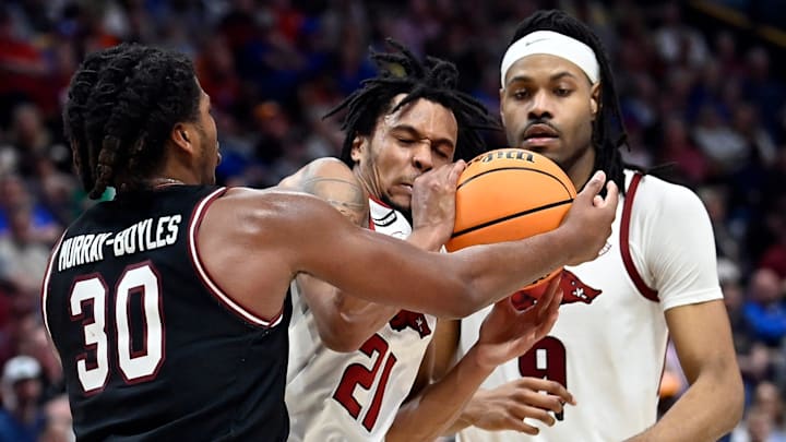 South Carolina forward Collin Murray-Boyles (30) and Arkansas guard D.J. Wagner (21) fight for the ball during a NCAA college basketball first round game at the men’s Southeastern Conference Tournament Wednesday, March 12, 2025, in Nashville, Tenn.