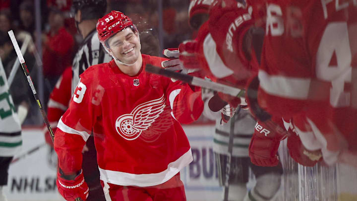 Detroit Red Wings right wing Alex DeBrincat (93) celebrates with his teammates by the team's bench.