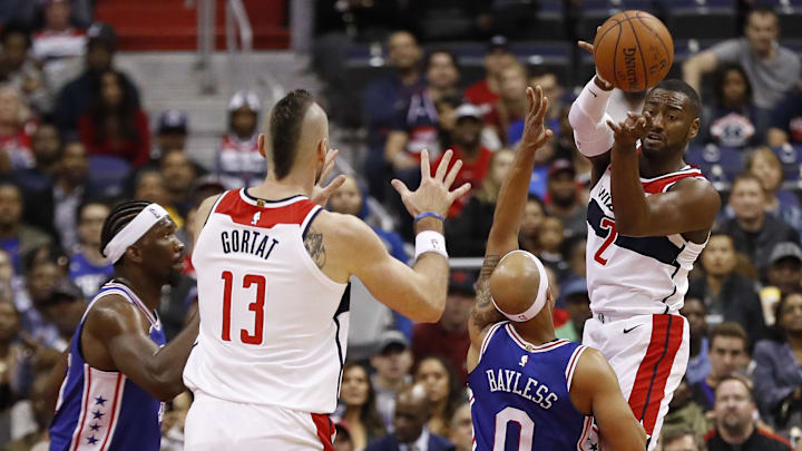 Oct 18, 2017; Washington, DC, USA; Washington Wizards guard John Wall (2) leaps to pass the ball to Wizards center Marcin Gortat (13) as Philadelphia 76ers guard Jerryd Bayless (0) defends in the first quarter at Capital One Arena. Mandatory Credit: Geoff Burke-Imagn Images Oct 18, 2017; Washington, DC, USA; Washington Wizards guard John Wall (2) leaps to pass the ball to Wizards center Marcin Gortat (13) as Philadelphia 76ers guard Jerryd Bayless (0) defends in the first quarter at Capital One Arena. Mandatory Credit: Geoff Burke-Imagn Images