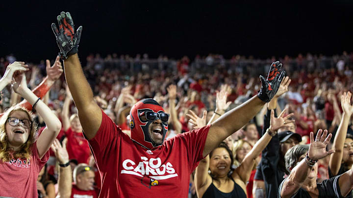 Fans cheer after the Louisville Cardinals beat UCF 42-35 after a wild end to the game with