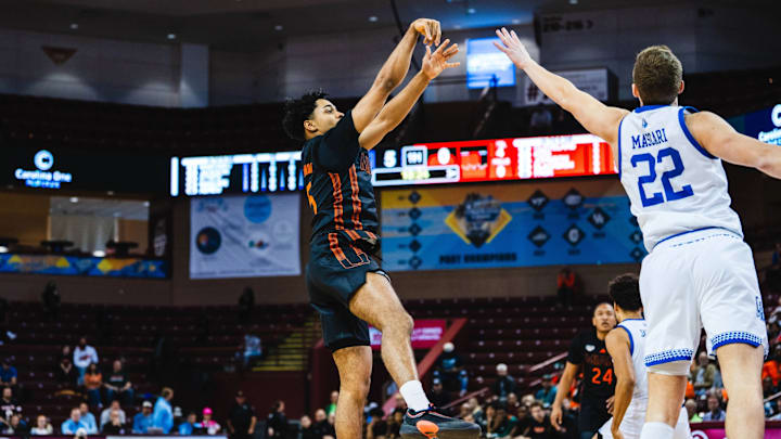 Miami guard Jalen Blackmon (5) looking for a shot against Drake 