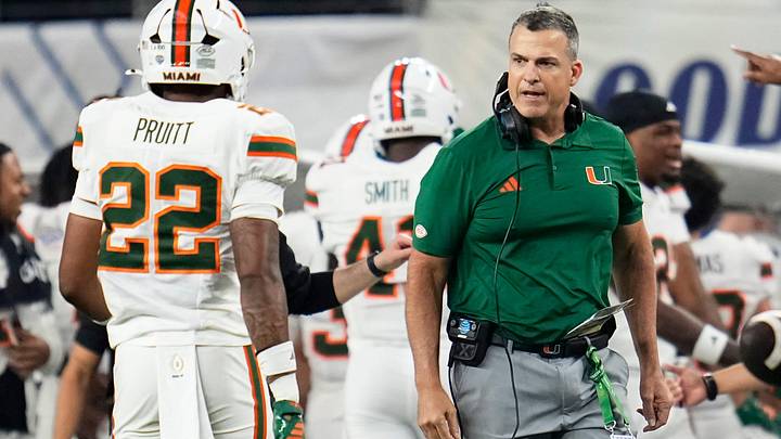 Miami Hurricanes head coach Mario Cristobal reacts beside linebacker Cameron Pruitt (22) during the Cotton Bowl at AT&T Stadium in Arlington, Texas for the College Football Playoff quarterfinal game against the Ohio State Buckeyes on Dec. 31, 2025.