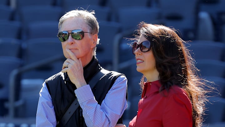Oct 1, 2025; Bronx, New York, USA; Boston Red Sox owner John Henry (left) stands on the field with his wife Linda Pizzuti Henry during batting practice before game two of the Wildcard round of the 2025 MLB playoffs against the New York Yankees at Yankee Stadium. Mandatory Credit: Brad Penner-Imagn Images