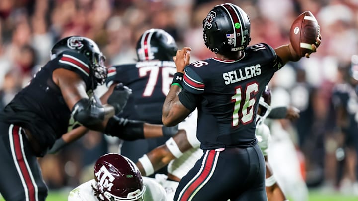 Nov 2, 2024; Columbia, South Carolina, USA; Texas A&M Aggies defensive lineman Shemar Turner (5) hits South Carolina Gamecocks quarterback LaNorris Sellers (16) in the knees, drawing a personal foul penalty, in the second quarter at Williams-Brice Stadium. Mandatory Credit: Jeff Blake-Imagn Images
