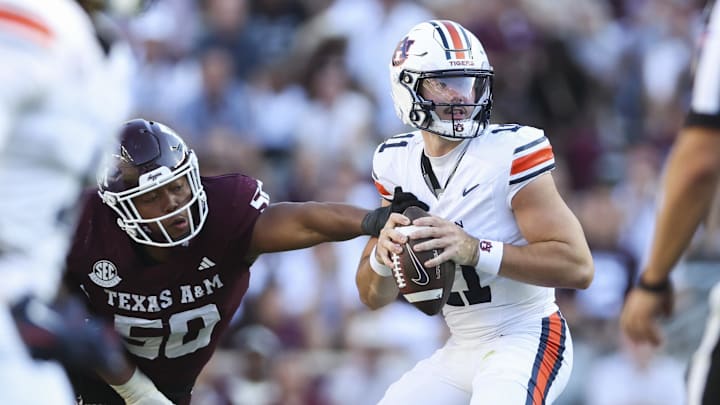 Auburn Tigers quarterback Jackson Arnold looks for an open receiver as Texas A&M Aggies defensive end Dayon Hayes attempts to make a tackle during the third quarter at Kyle Field.