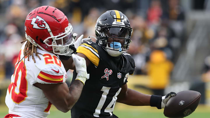 ittsburgh Steelers wide receiver George Pickens (14) runs after a catch as Kansas City Chiefs safety Justin Reid (20) defends during the fourth quarter  at Acrisure Stadium. 