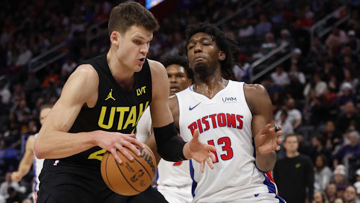 Dec 21, 2023; Detroit, Michigan, USA;  Utah Jazz center Walker Kessler (24) is defended by Detroit