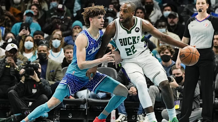 Jan 8, 2022; Charlotte, North Carolina, USA; Milwaukee Bucks forward Khris Middleton (22) controls the ball against Charlotte Hornets guard LaMelo Ball (2) during the first quarter at the Spectrum Center. Jan 8, 2022; Charlotte, North Carolina, USA; Milwaukee Bucks forward Khris Middleton (22) controls the ball against Charlotte Hornets guard LaMelo Ball (2) during the first quarter at the Spectrum Center.