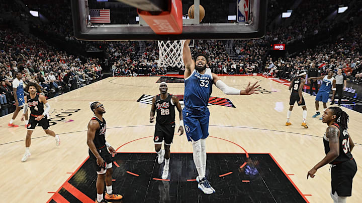 Feb 15, 2024; Portland, Oregon, USA; Minnesota Timberwolves center Karl-Anthony Towns (32) dunks the basketball during the second half against Portland Trail Blazers center Duop Reath (26) at Moda Center. Mandatory Credit: Troy Wayrynen-Imagn Images