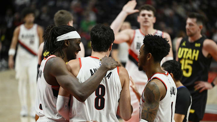 Oct 18, 2024; Portland, Oregon, USA; Portland Trail Blazers forward Deni Avdija (8) is helped up during the second half by teammates Portland Trail Blazers forward Jerami Grant (9), left, and guard Anfernee Simons (1) against the Utah Jazz at Moda Center. Mandatory Credit: Troy Wayrynen-Imagn Images Oct 18, 2024; Portland, Oregon, USA; Portland Trail Blazers forward Deni Avdija (8) is helped up during the second half by teammates Portland Trail Blazers forward Jerami Grant (9), left, and guard Anfernee Simons (1) against the Utah Jazz at Moda Center. Mandatory Credit: Troy Wayrynen-Imagn Images