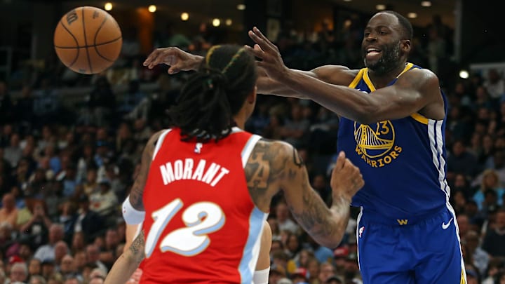 Apr 1, 2025; Memphis, Tennessee, USA; Golden State Warriors forward Draymond Green (23) passes the ball as Memphis Grizzlies guard Ja Morant (12) defends during the fourth quarter at FedExForum. Mandatory Credit: Petre Thomas-Imagn Images