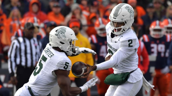 Nov 16, 2024; Champaign, Illinois, USA; Michigan State Spartans quarterback Aidan Chiles (2) hands the ball to running back Nate Carter (5) during the first half against the Illinois Fighting Illini at Memorial Stadium. Mandatory Credit: Ron Johnson-Imagn Images