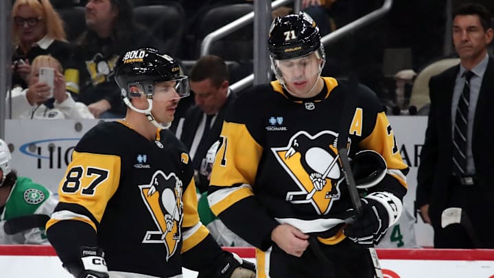 Nov 11, 2024; Pittsburgh, Pennsylvania, USA;  Pittsburgh Penguins center Sidney Crosby (87) and center Evgeni Malkin (71) react on the ice against the Dallas Stars during the third period at PPG Paints Arena. Mandatory Credit: Charles LeClaire-Imagn Images