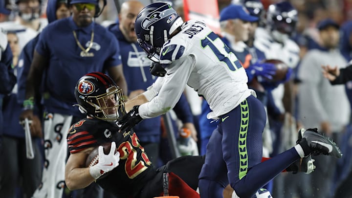 Jan 3, 2026; Santa Clara, California, USA; Seattle Seahawks linebacker Ernest Jones IV (13) tackles San Francisco 49ers running back Christian McCaffrey (23) during the first half at Levi's Stadium. Mandatory Credit: Sergio Estrada-Imagn Images