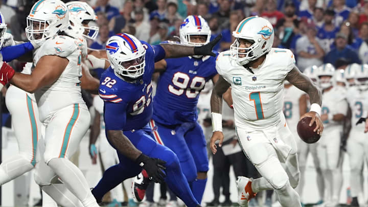 Miami Dolphins quarterback Tua Tagovailoa (1) looks to pass against Buffalo Bills defensive tackle Daquan Jones (92) in the third quarter at Highmark Stadium. Miami Dolphins quarterback Tua Tagovailoa (1) looks to pass against Buffalo Bills defensive tackle Daquan Jones (92) in the third quarter at Highmark Stadium.