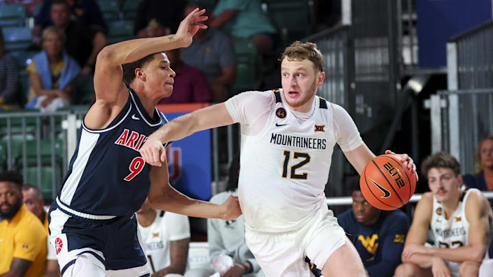 West Virginia Mountaineers guard Tucker DeVries (12) drives to the basket as Arizona Wildcats forward Carter Bryant (9) defends during the second half at Imperial Arena at the Atlantis resort.
