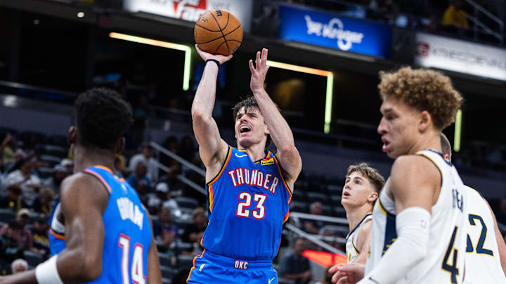 Oct 11, 2025; Indianapolis, Indiana, USA; Oklahoma City Thunder guard Brooks Barnhizer (23) shoots the ball while Indiana Pacers guard Johnny Furphy (12) defends in the second half at Gainbridge Fieldhouse. Mandatory Credit: Trevor Ruszkowski-Imagn Images Oct 11, 2025; Indianapolis, Indiana, USA; Oklahoma City Thunder guard Brooks Barnhizer (23) shoots the ball while Indiana Pacers guard Johnny Furphy (12) defends in the second half at Gainbridge Fieldhouse. Mandatory Credit: Trevor Ruszkowski-Imagn Images
