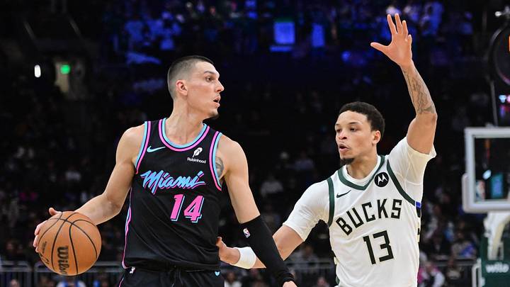 Feb 24, 2026; Milwaukee, Wisconsin, USA;  Miami Heat guard Tyler Herro (14) looks for a shot against Milwaukee Bucks guard Ryan Rollins (13) in the fourth quarter at Fiserv Forum. Mandatory Credit: Benny Sieu-Imagn Images