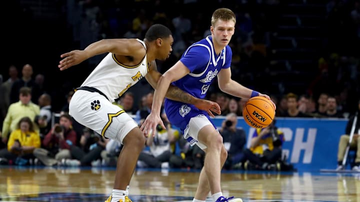Mar 20, 2025; Wichita, KS, USA; Drake Bulldogs guard Bennett Stirtz (14) dribbles against Missouri Tigers guard Tony Perkins (12) in the first half of a first round men’s NCAA Tournament game at Intrust Bank Arena. Mandatory Credit: Nick Tre. Smith-Imagn Images