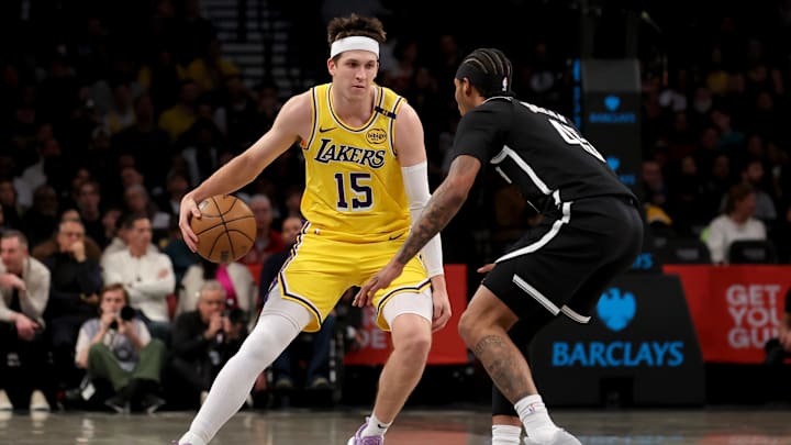 Mar 10, 2025; Brooklyn, New York, USA; Los Angeles Lakers guard Austin Reaves (15) controls the ball against Brooklyn Nets guard Keon Johnson (45) during the first quarter at Barclays Center. Mandatory Credit: Brad Penner-Imagn Images