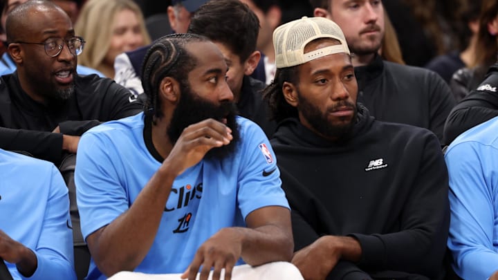 Los Angeles Clippers guard James Harden and Kawhi Leonard watch the game against the Utah Jazz.
