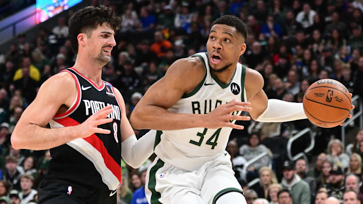 Jan 4, 2025; Milwaukee, Wisconsin, USA;  Milwaukee Bucks forward Giannis Antetokounmpo (34) drives for the basket against Portland Trail Blazers forward Deni Avdija (8) in the fourth quarter at Fiserv Forum. Mandatory Credit: Benny Sieu-Imagn Images